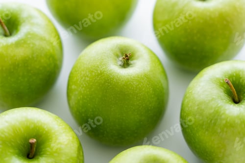 Preview: close up of delicious green apples on white