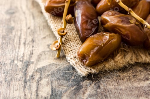 Preview: Fresh dates fruit branch on rustic wooden table