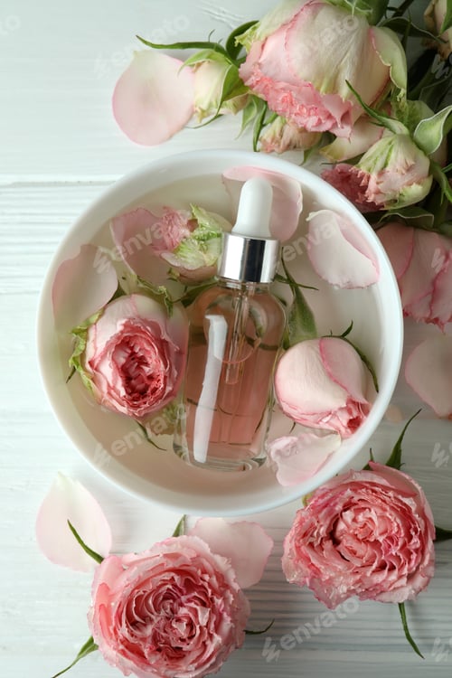 Preview: Skin care concept with essential rose oil on white wooden table