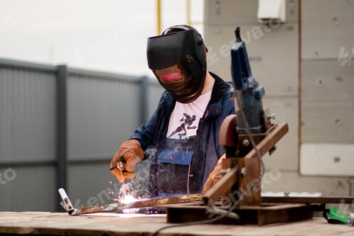 Preview: The man works with a welding machine.