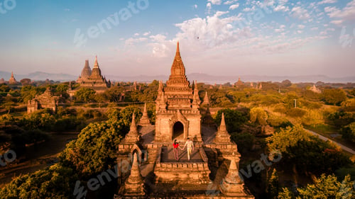 Preview: Bagan Myanmar, couple of men and woman looking at the sunrise on top of an old pagoda temple