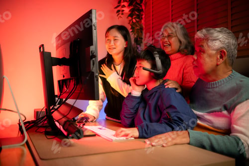 Preview: Happy grandparents playing games with grandchildren in in a neon lit room