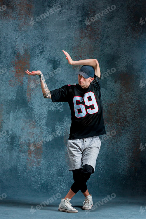 Preview: Young man break dancing on wall background.