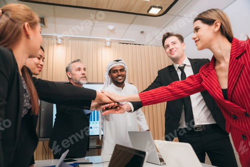Preview: A group of happy, successful businesspeople are laughing and giving each other Stack of hands.