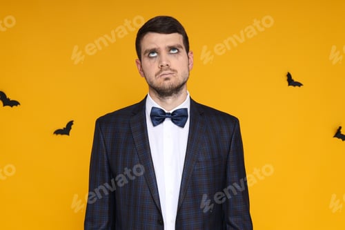 Preview: A man in a business suit with zombie makeup on a yellow background