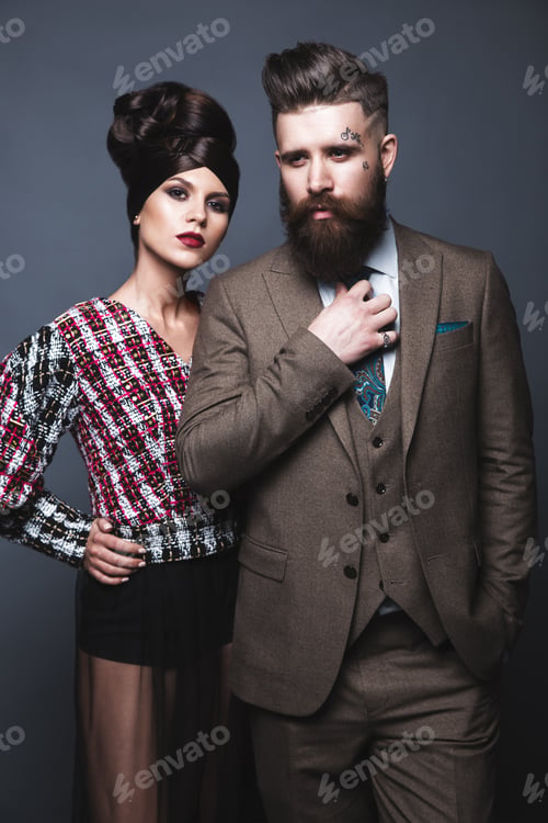 Preview: Couple, man and woman in evening dresses posing for studio photo shoot.