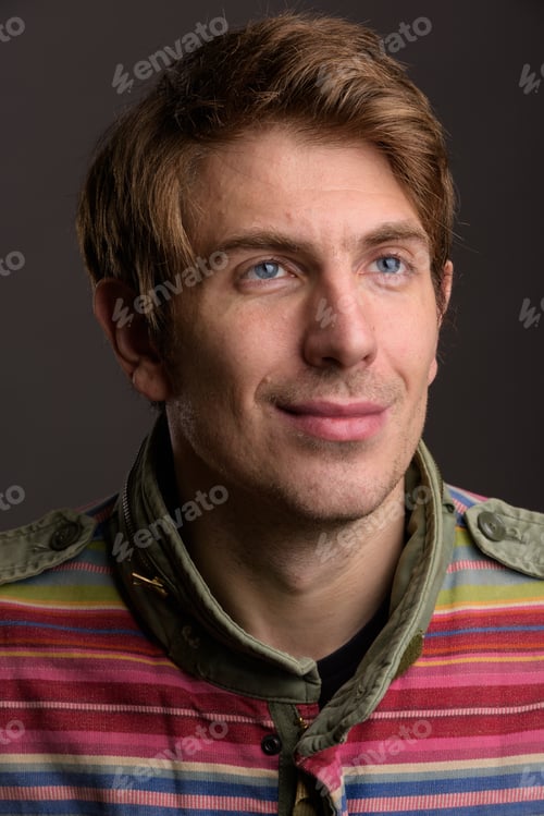 Preview: Portrait of handsome man against gray background