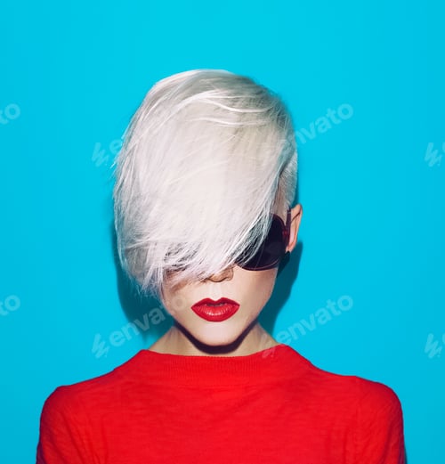 Preview: fashion blond woman with trendy hairstyle and sunglasses on a bl