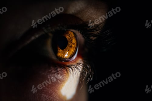 Preview: Macro closeup shot of a human eye looking to a small light from a dark room