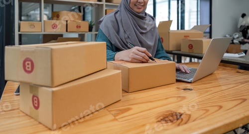 Preview: Muslim female small business owner entrepreneur packing package post shipping box preparing