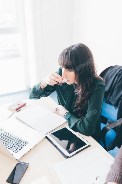 Preview: Woman Drinks Water at Desk with Technology