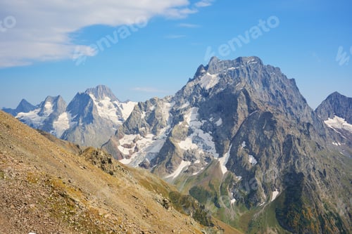 Preview: Nature landscape scene of Dombay Ulgen mountain range at day.