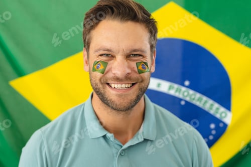 Preview: Image of happy caucasian man with flags of brazil on face over flag of brazil