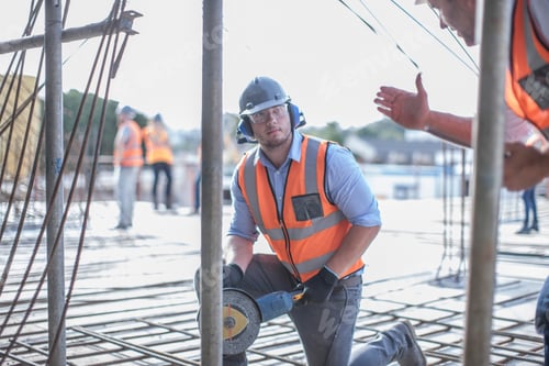 Preview: Site manager explaining to builder on construction site