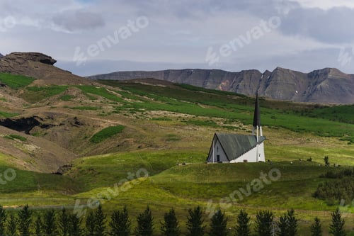 Preview: Church on a grassy hill in the distance under a cloudy sky