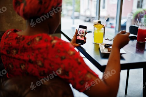 Preview: Stylish african woman in red shirt and hat