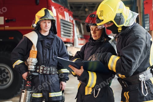 Preview: With notepad. Group of firefighters in protective uniform that is on station