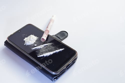 Preview: Smartphone on a white background with cocaine and a banknote on it