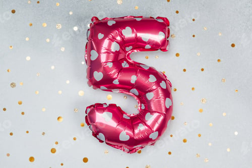 Preview: Bright pink heart balloon shaped like number five on festive backdrop