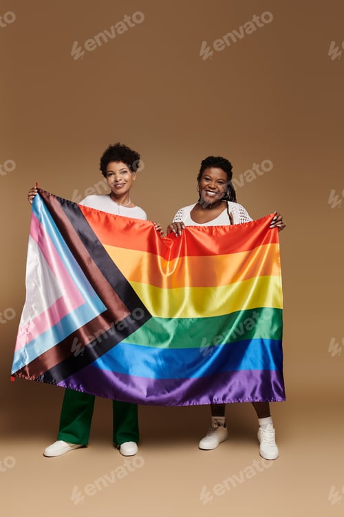 Preview: Celebrating love and pride with a fashionable lesbian couple against a vibrant backdrop