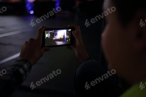 Preview: Little boy taking picture with smartphone