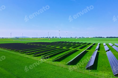 Preview: Solar panels in green field, aerial view