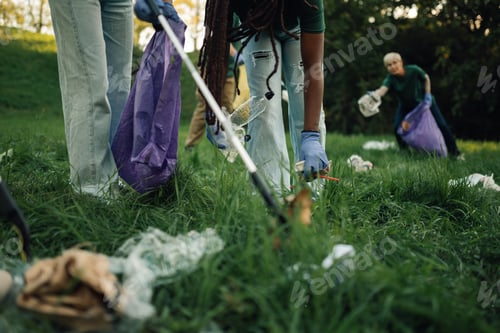 Preview: Group of people volunteers collecting rubbish in park