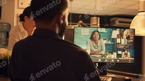 Preview: Office worker attending online videocall meeting on computer