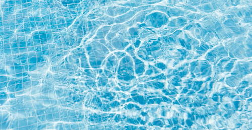 Preview: Clear water surface with ripple wave splashes and drops in swimming pool. Banner.
