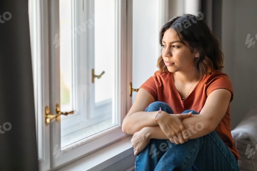 Preview: Portrait Of Pensive Young Middle Eastern Woman Sitting Near Window At Home