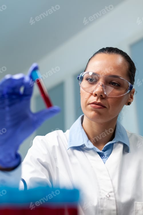 Preview: Scientist doctor holding blood vacutainer analyzing during biochemistry experiment