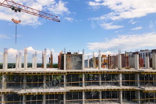 Preview: Tower crane at high concrete residential building under construction.