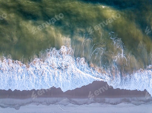 Preview: Drone picture of waves hitting the beach.
