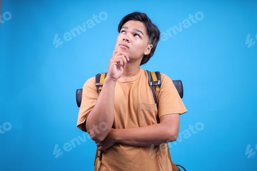 Preview: Thoughtfully Young Traveler Male Carry Backpack Stuff Mat Thinking With Hand On Chin