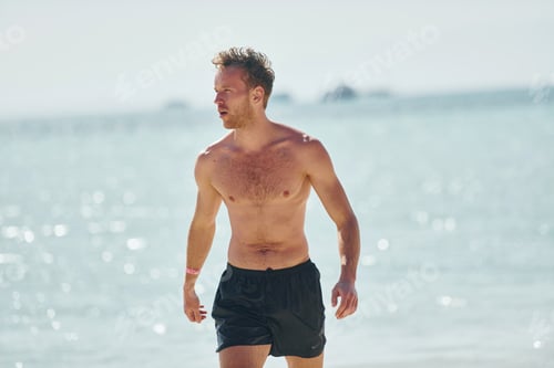 Preview: Clear water. Young european man have vacation and enjoying free time on the beach of sea