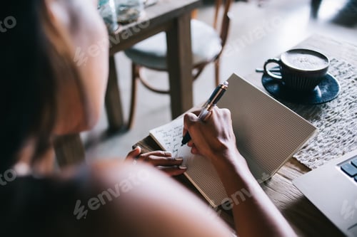 Preview: Female author composing letter in notepad