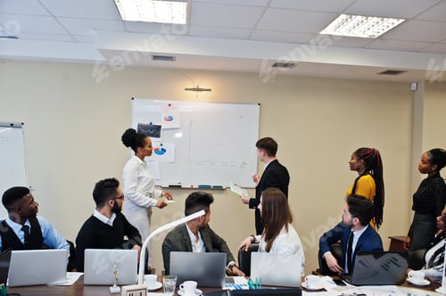 Preview: Multiracial young creative people in modern office