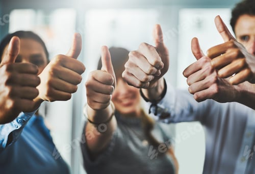 Preview: Closeup shot of a group of businesspeople showing thumbs up in an office