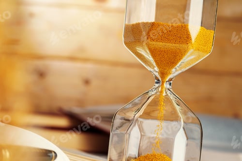 Preview: Hourglass with sand close up on wooden background