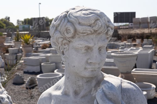 Preview: Ancient stone sculpture of man in reclamation yard