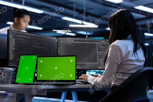 Preview: Coworkers in data center using green screen laptop and tablet