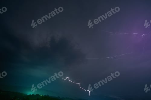 Preview: Stormy dark cloud with lightning over mountains