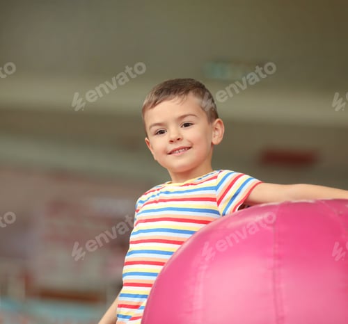 Preview: Cute little child playing at indoor amusement park