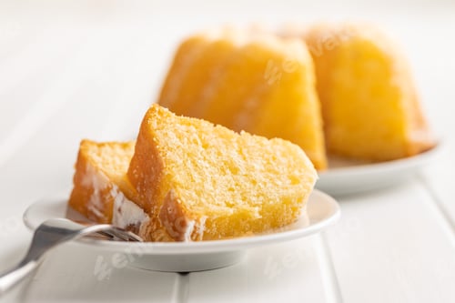 Preview: Sweet sponge cake. Bundt cake on plate on white table.