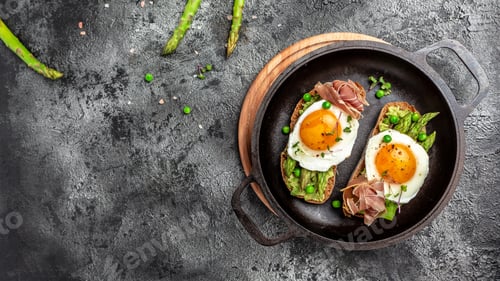 Preview: Breakfast with asparagus, egg, bacon and toast on dark background. Long banner format, top view