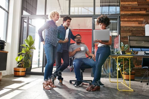Preview: Multiracial group of designers meeting in modern office