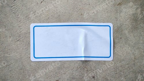 Preview: Blank White Label with Blue Border on a Textured Concrete Background