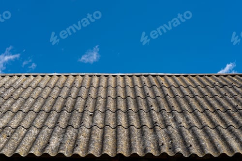 Preview: An old brick barn in the Polish countryside with a corrugated asbestos roof.