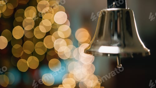 Preview: Shaking and ringing bell with blurred Christmas background