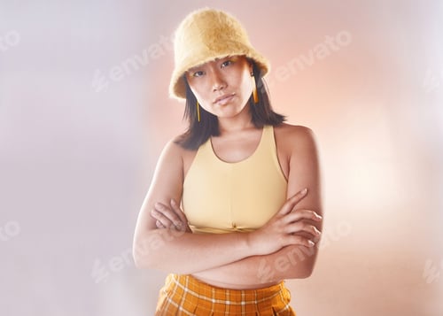 Preview: Arms crossed, fashion and portrait of an Asian woman with style isolated on a studio background. Tr